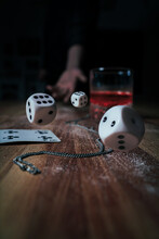 Closeup Of Dices Being Thrown On A Table