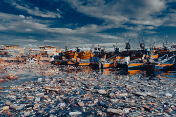 Wall Mural - Photo of boats in a port and small rocks on the ground