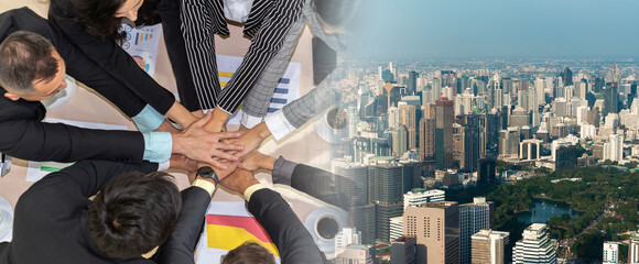 Happy business people celebrate teamwork success together with joy at office table shot from top view . Young businessman and businesswoman workers express cheerful victory in broaden view .