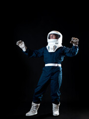 Wall Mural - The astronaut is floating in weightlessness. The hero of the science fiction story is a pioneer of space exploration. A young man in a space suit
