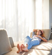 © Marius Venter/peopleimages.com - Its always a good time to relax. Shot of a young woman asleep on her sofa.