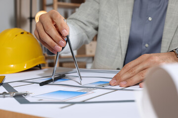 Wall Mural - Architect working with construction drawings in office, closeup