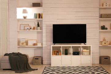 Wall Mural - Modern TV on cabinet, ottoman and decor elements in living room