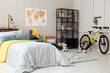 © New Africa - Stylish teenager's room interior with comfortable bed and sports equipment