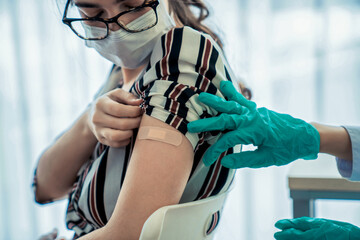 Young woman visits skillful doctor at hospital for vaccination . Covid 19 and coronavirus vaccination center service concept .