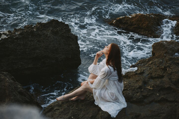 woman with wet hair in white dress stones nature travel unaltered