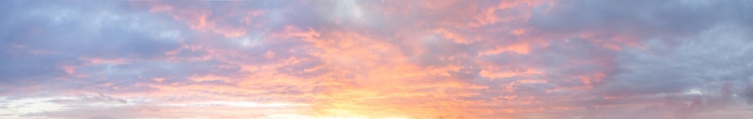 Panoramic bright colorful sunset sky with clouds, nature background