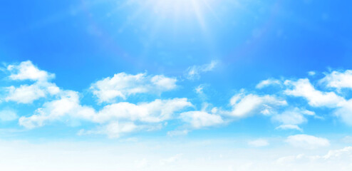 Wall Mural - sunny day background, blue sky with white cumulus clouds and glaring sun