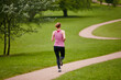 © D Laflor/peopleimages.com - Just her and the path. Rearview shot of a woman jogging along a foothpath in a park.