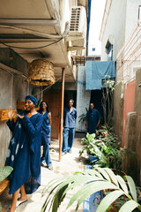 Wall Mural - portrait of eco african textile designers smiling and posing together