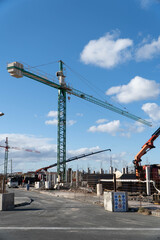 Wall Mural - Vertical shot of a construction site with a male Caucasian worker in Spain