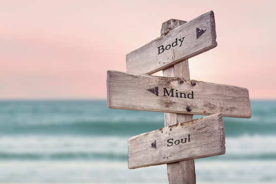 Wall Mural - body mind soul text quote written on wooden signpost by the sea. Positive pink turqoise pastel theme.
