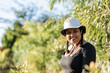 Beautiful smiling latina woman with hat outdoors on a sunny day looking into camera 