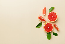 Fresh Fruit Grapefruit With Juicy Grapefruit Slices On Colored Background. Top View. Copy Space. Creative Summer Concept. Half Of Citrus In Minimal Flat Lay With Copy Space