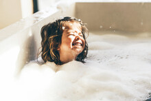 Little Girl In Bath Playing With Foam.