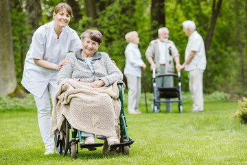 Happy senior woman and helpful caregiver, nursing home concept photos