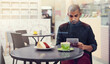 © Thurstan Hinrichsen/peopleimages.com - I come for the coffee but mostly for free wifi. Shot of a young man sitting in a cafe with his digital tablet.