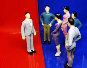 Danish politics symbolised by figurines debating in a blue and a red area where the politicians confront each other