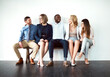 © Arnéll K/peopleimages.com - So what are you guys doing today. Shot of a group of work colleagues seated next to each other against a white background.