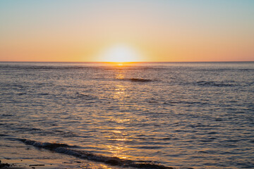 Sticker - Sunrise just on horizon starts to illuminate and warm the air over sea of Tokomaru Bay