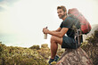 © Mikolette Moller/peopleimages.com - The perfect day to be out in nature.... Shot of a young man taking a water break while out hiking.