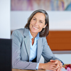 shes got what it takes to succeed. portrait of a mature businesswoman sitting at her office desk.