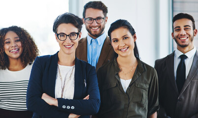 Sticker - Watch us rise to the next level. Portrait of a diverse team of professionals standing together in an office.