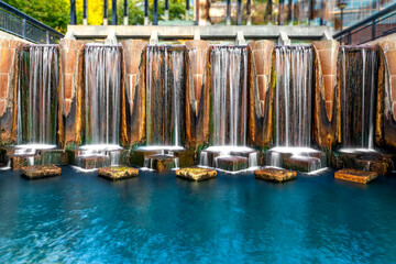 A beautiful man-made waterfall splashes down at one end of the walk along the old Indiana Central Canal in the city of Indianapolis.