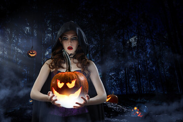 Wall Mural - beautiful young woman in witches hat and costume