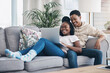 © Nicholas F/peopleimages.com - Nothing says romance like a cosy weekend at home. Shot of a young couple using a laptop while relaxing on the sofa at home.