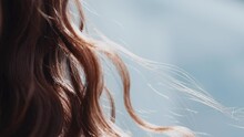 Woman With Curly Red Hair Waved By Light Wind At Sunlight
