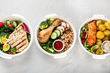 Wall Mural - Healthy meal prep in lunch boxes on light background.