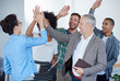 © Yuri A/peopleimages.com - Successful and loving it. Shot of a group of happy coworkers high-fiving while standing in an office.