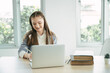 © chachamp - Happy girl student online learning class with laptop computer at home