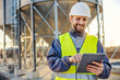 © Dusan Petkovic - An industry worker using tablet for checking on supply in silos.