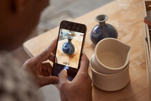 Male Ceramist Taking Picture Of Pottery Product