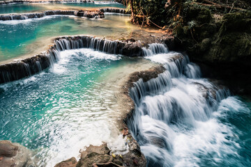 Wall Mural - amazing turquoise water of kuang si waterfall in tropical rain forest. laos