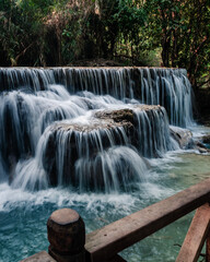 Wall Mural - amazing turquoise water of kuang si waterfall in tropical rain forest. laos