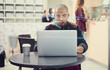 © Thurstan H/peopleimages.com - Enjoying some online time at his favourite cafe. Shot of a young man using his laptop in a coffee shop.