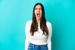 © luismolinero - Young caucasian woman isolated on blue background shouting to the front with mouth wide open