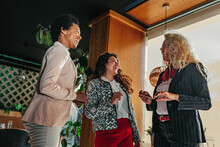 Three Diverse Businesswomen At Cafe Socializing