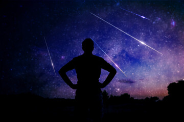 Wall Mural - silhouette of a man enjoying countryside under the starry skies.
