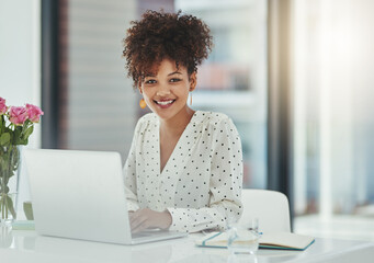 Poster - Success is her game. Shot of a beautiful young businesswoman working in her office.