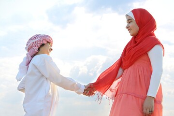 Wall Mural - Beautiful Arabic girl with family enjoying in nature