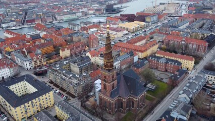 Wall Mural - Aerial drone footage of the Christiana district and the Vor Frelsers church with its famous bellt tower in Copenhagen in winter in Denmark capital city