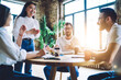 © BullRun - Laughing diverse colleagues discussing business ideas