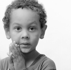 Sticker - little boy praying to God with hands together with people stock photo