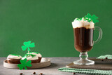 Irish coffee and tradition cupcakes for St Patricks Day on green background. Happy st patricks day.