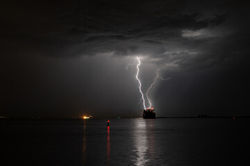 Wall Mural - lightning strikes at sea near a ship