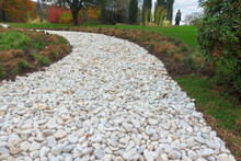 Walkway In The Park Of White Gravel.